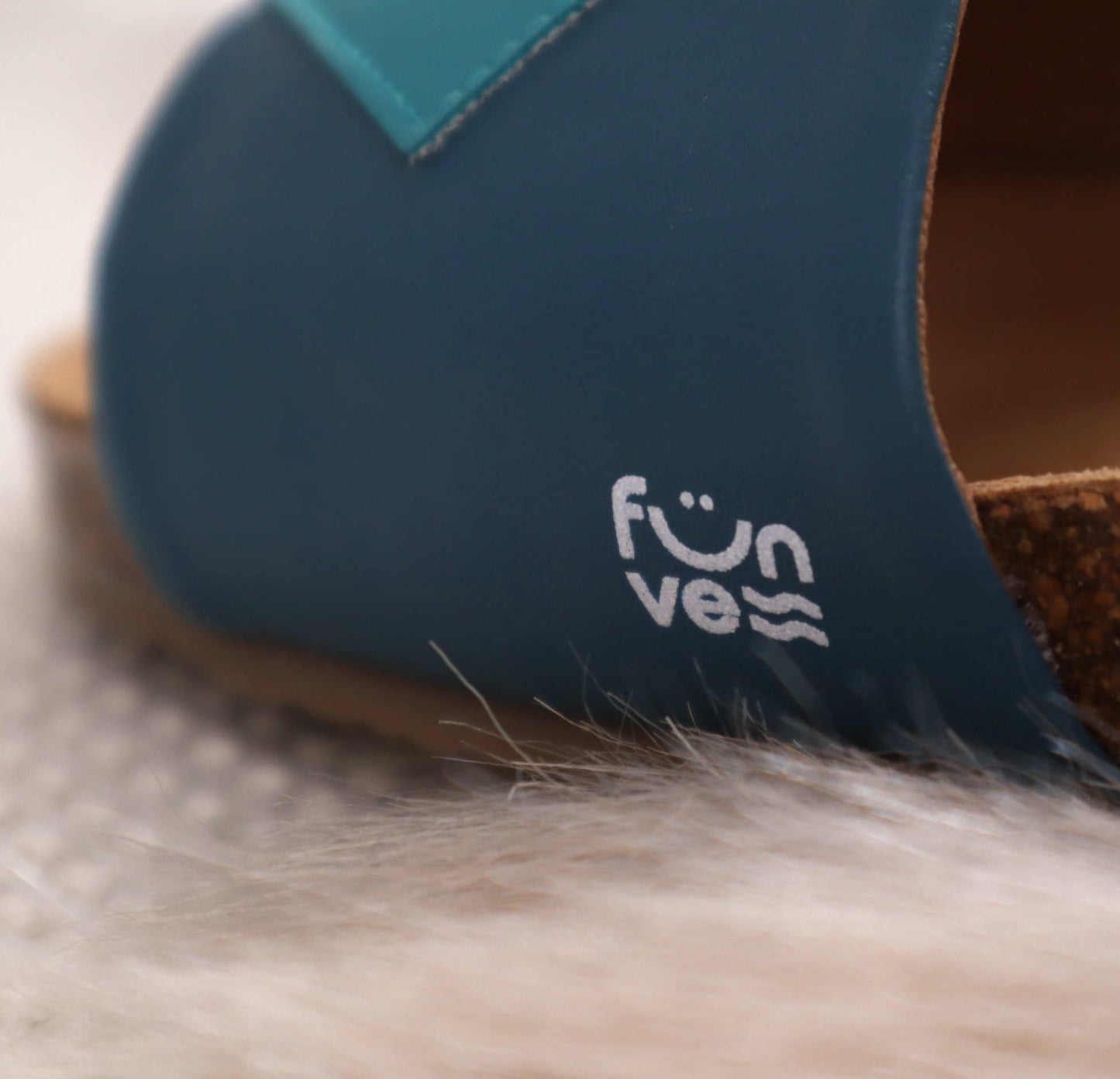 Grüne Hausschuhe mit Fußbett aus Kork, vegan, bequem, Korksohle, Closeup vom Logo Marke: Fünve, Modell: Cucumber